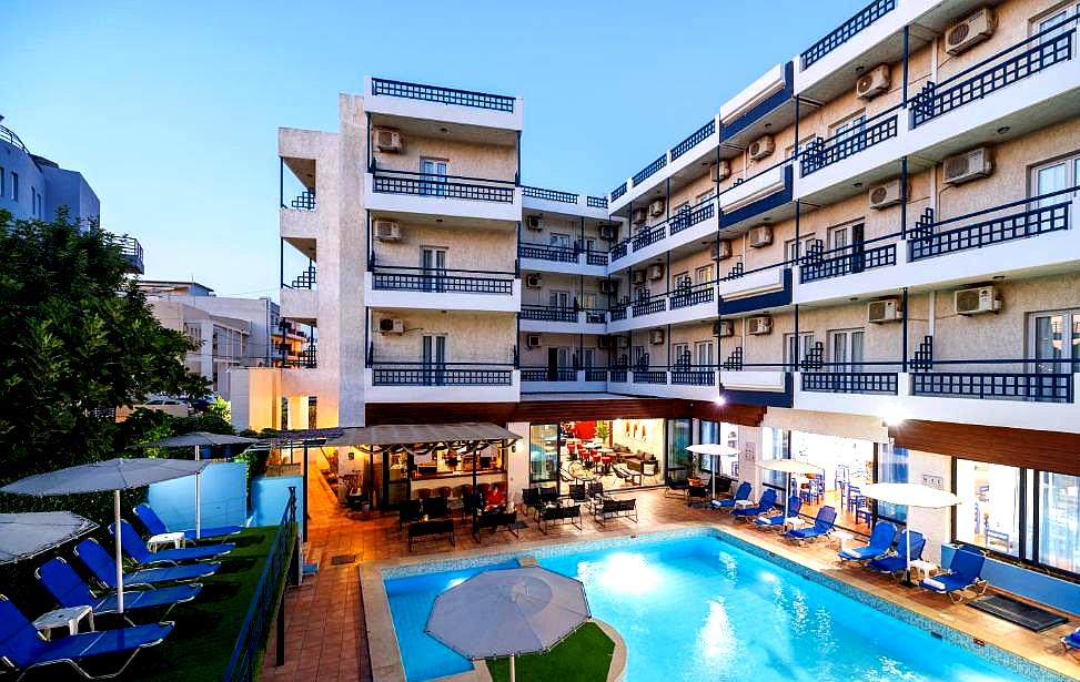 evening view of hotel pool area with lounge chairs