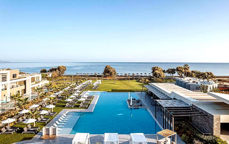 expansive pool with sea view and lounge chairs