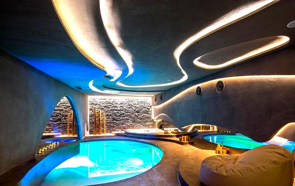 futuristic indoor pool with curved lighting and relaxation areas