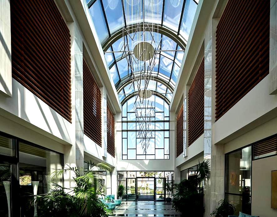 grand atrium with glass ceiling and modern chandelier