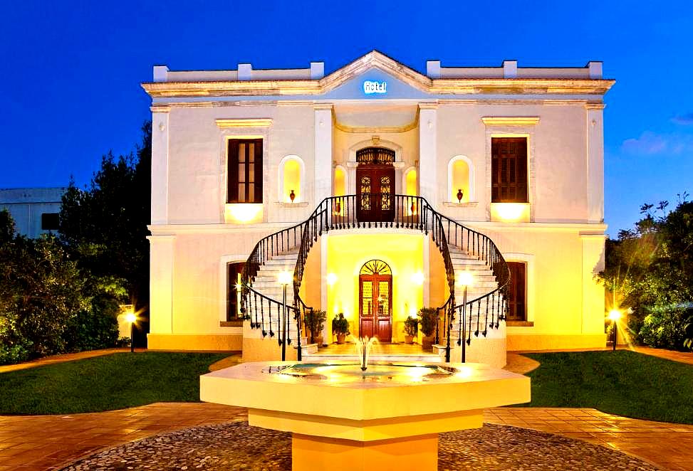 grand historic hotel entrance with sweeping staircase and fountain