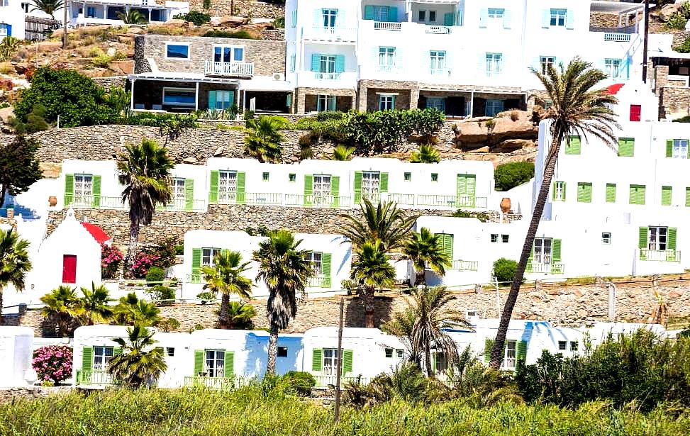 hillside resort with white buildings and palm trees