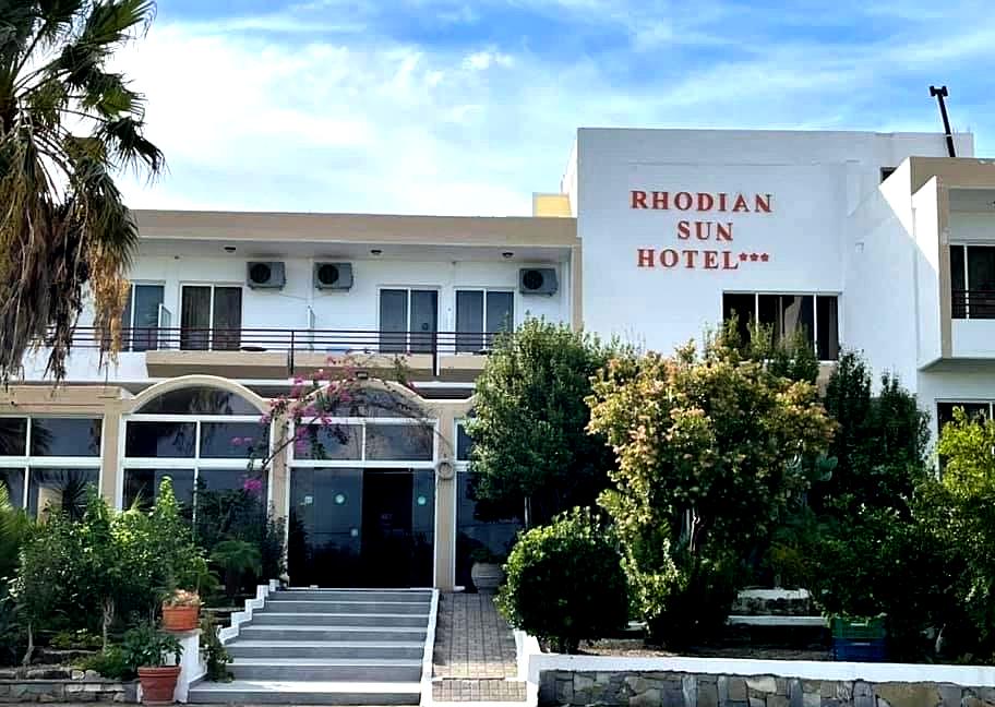 hotel entrance with garden and palm trees