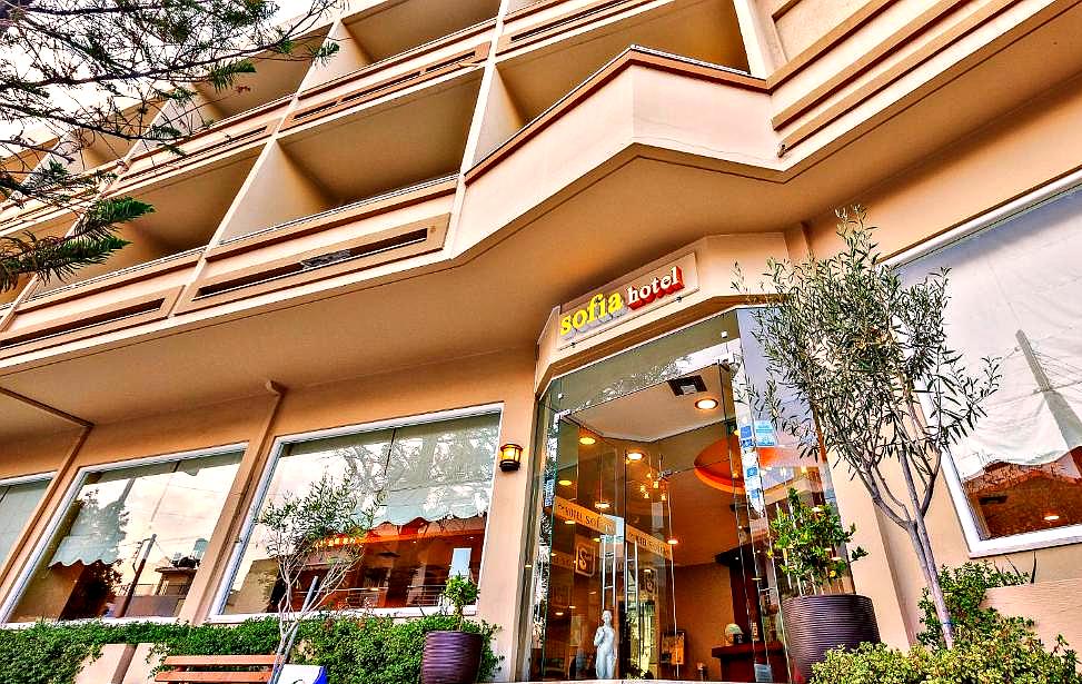 hotel entrance with glass doors and balconies