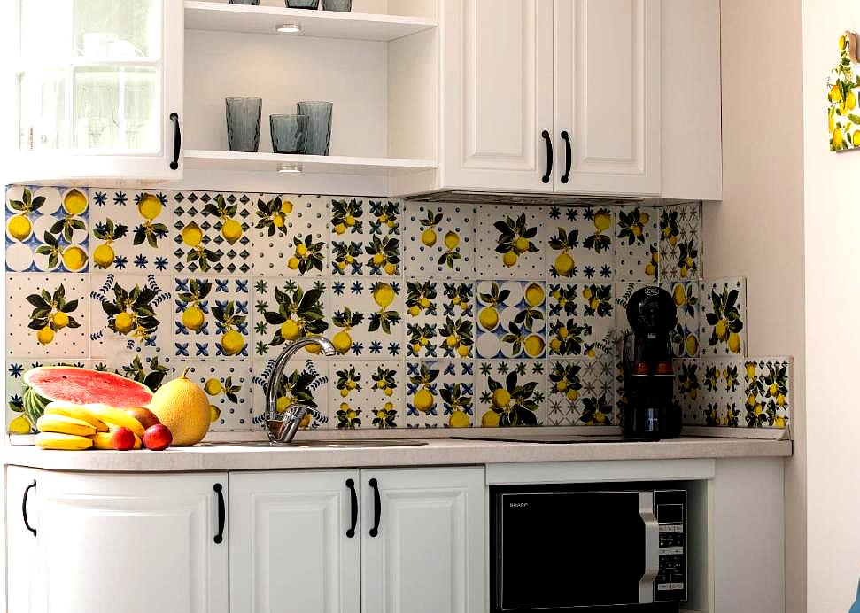 hotel room with charming kitchenette with vibrant tiled backsplash