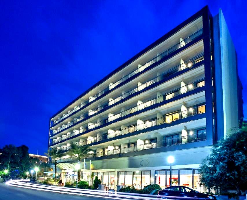 illuminated hotel exterior with balconies at night