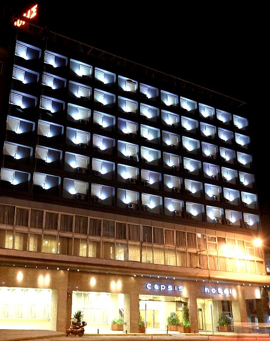 illuminated hotel facade at night with balconies