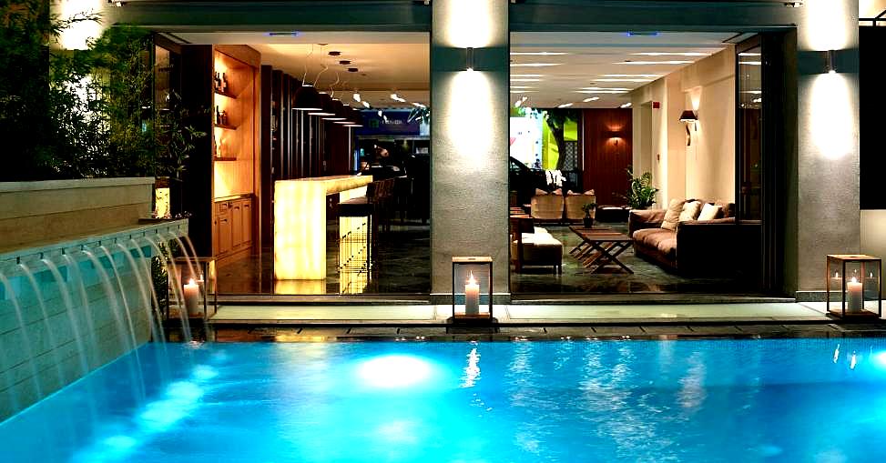 illuminated indoor pool with bar lounge view