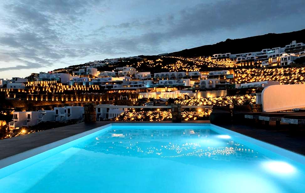 illuminated infinity pool overlooking sea at night