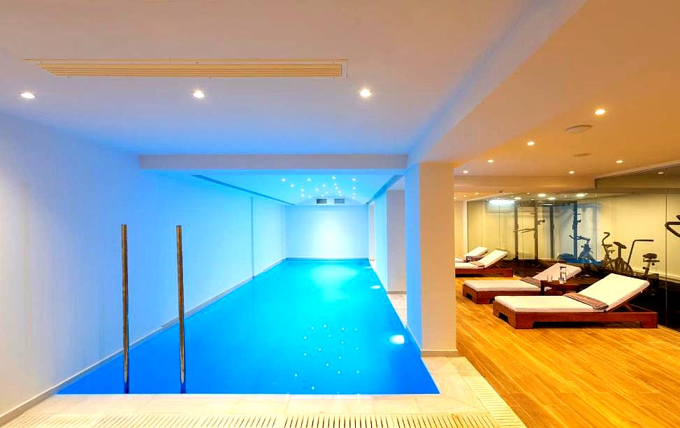 indoor swimming pool with lounge area and fitness facilities