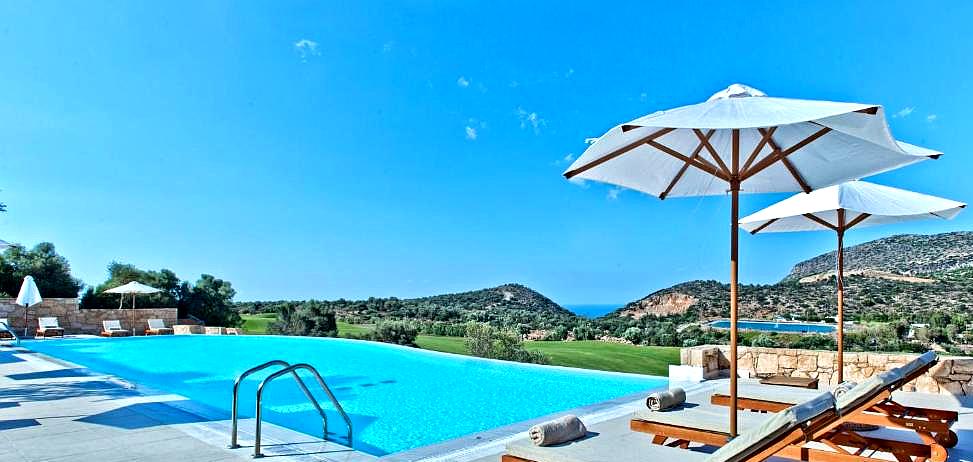 infinity pool overlooking sea and surrounding landscape