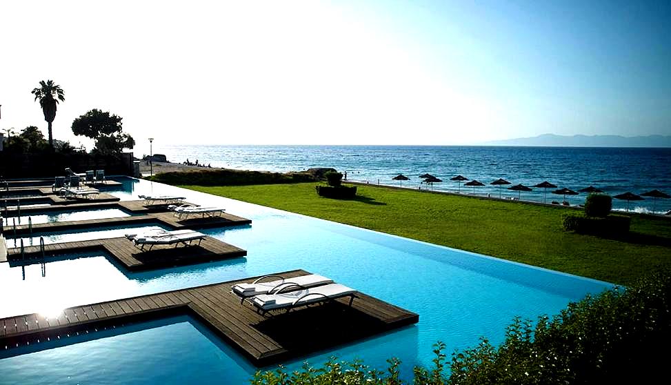 infinity pool overlooking sea with loungers and umbrellas