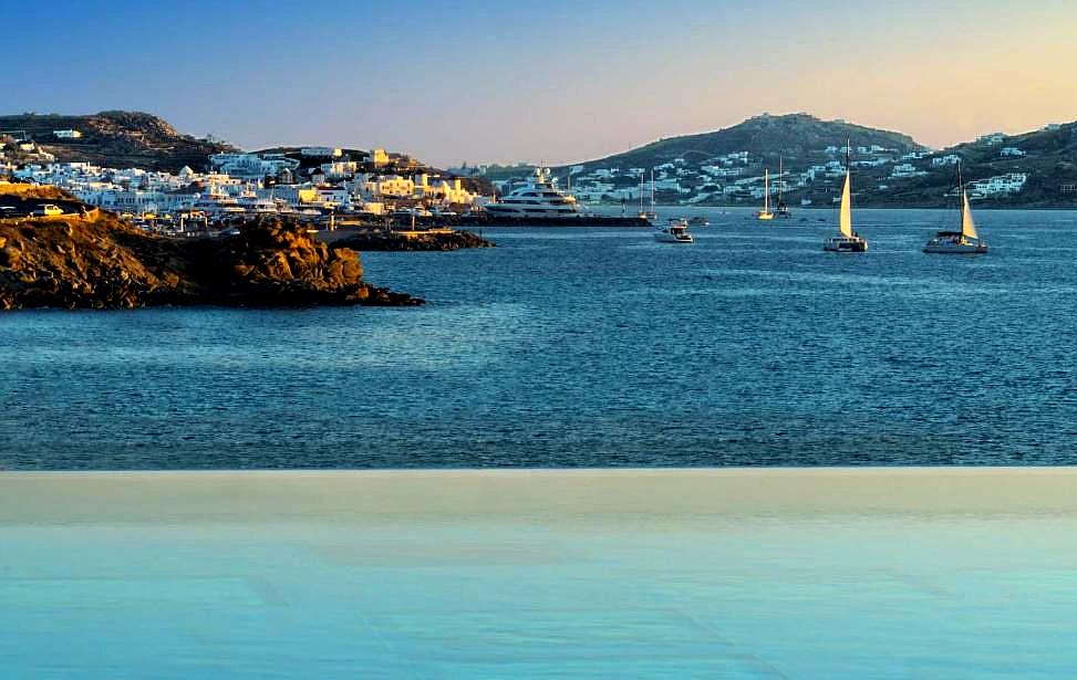 infinity pool with panoramic sea view at sunset