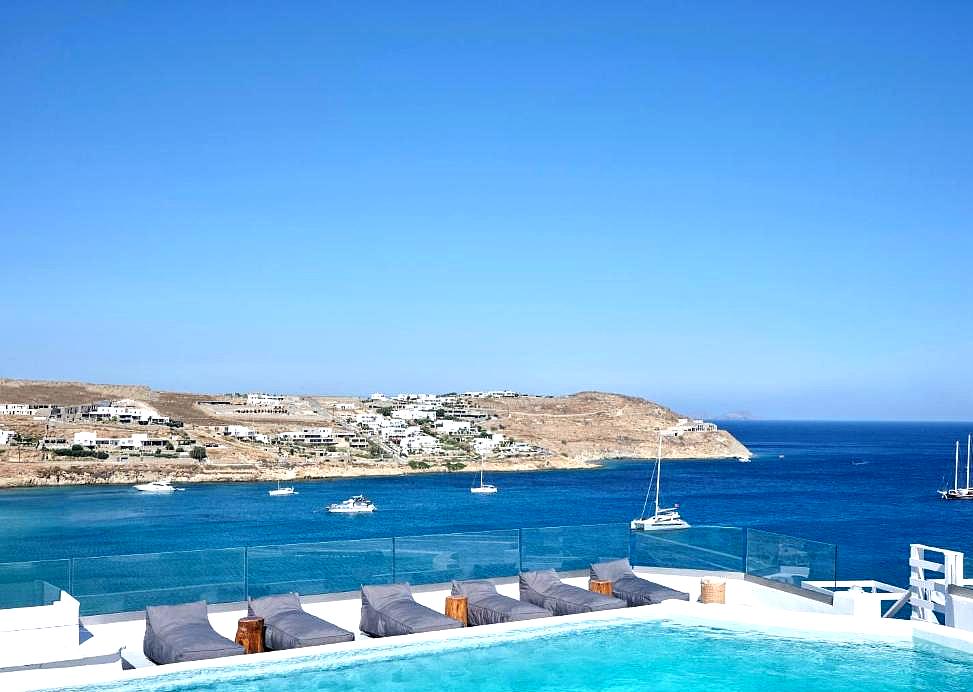 infinity pool with sea view and lounge beds