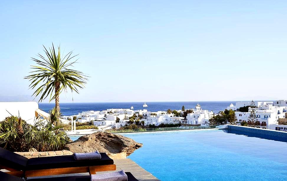 infinity pool with sea view and lounge chairs