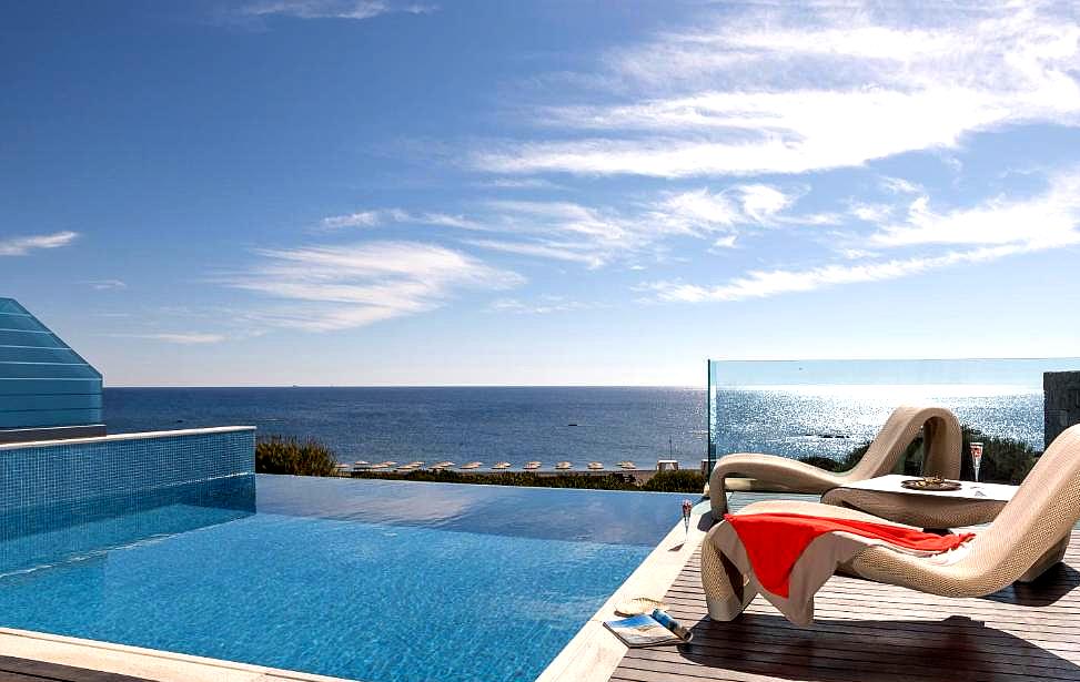 infinity pool with sea view and loungers