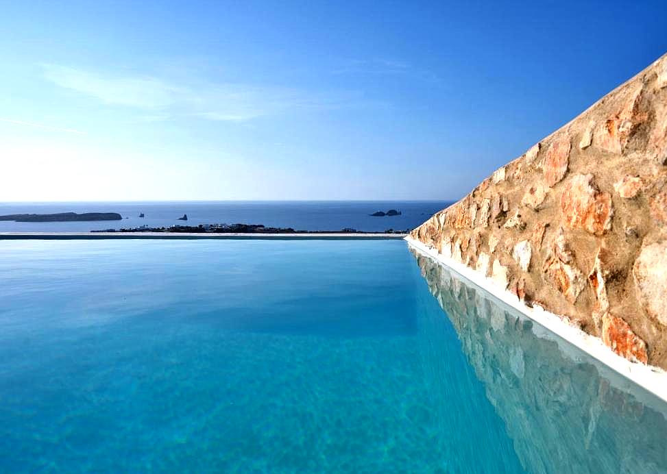 infinity pool with sea view and stone wall