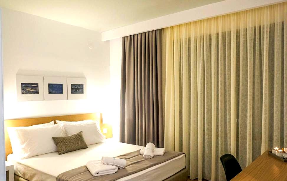 inviting hotel room with cozy lighting and elegant curtains