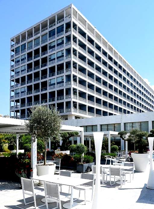 large modern hotel exterior with outdoor seating area