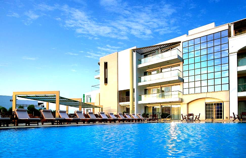 large outdoor pool with modern hotel backdrop