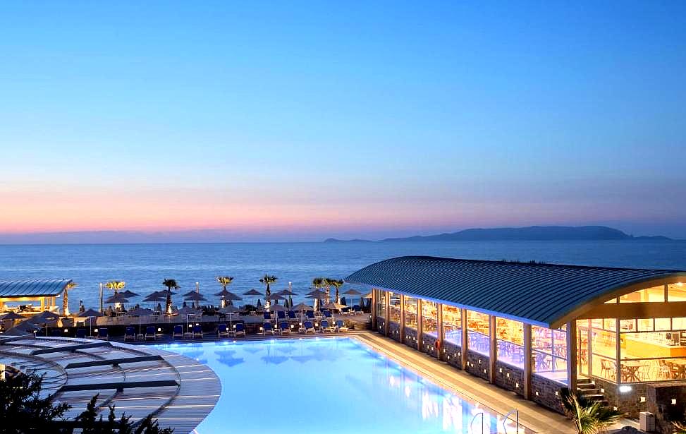 large swimming pool overlooking the sea at sunset