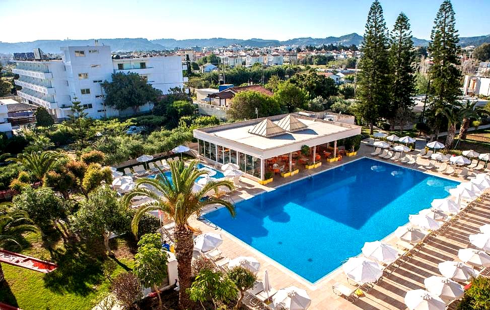 large swimming pool surrounded by lush greenery