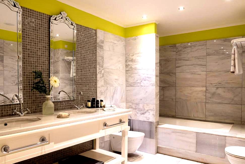 luxurious bathroom with dual sinks and marble finishes