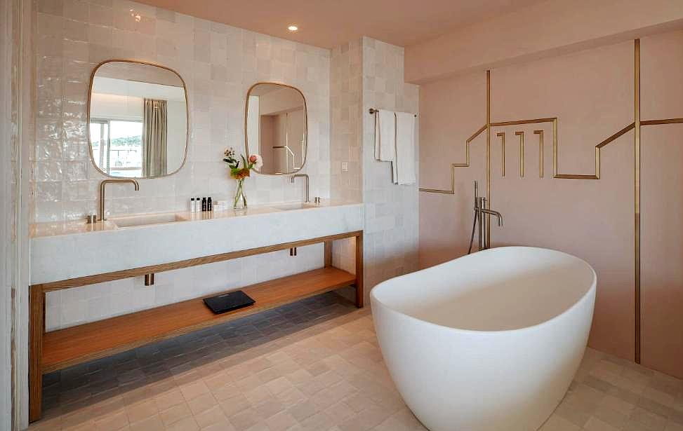 luxurious bathroom with freestanding tub and dual sinks