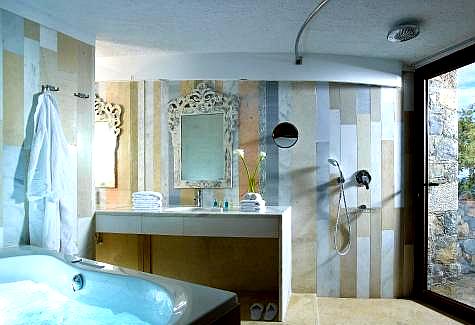 luxurious bathroom with marble accents and walk in shower