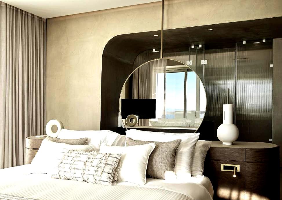 luxurious bedroom with round mirror