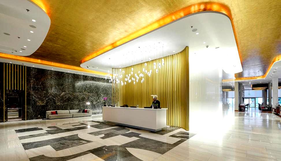 luxurious hotel lobby with golden ceiling and modern design