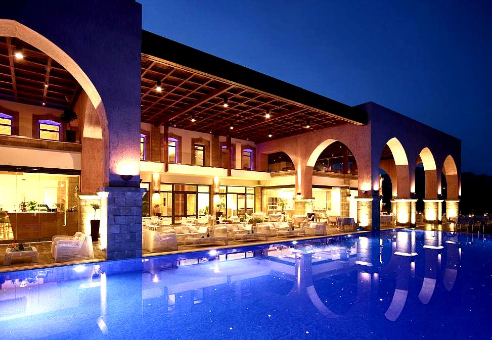 luxurious hotel poolside with arches and night lighting