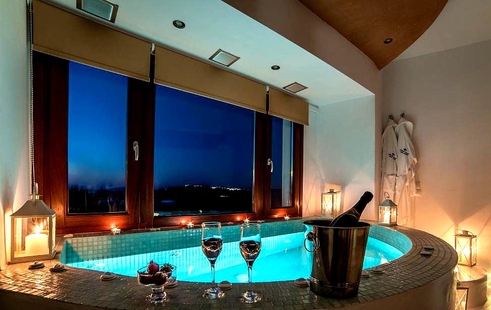 luxurious indoor hot tub with candle lit ambiance and panorama view