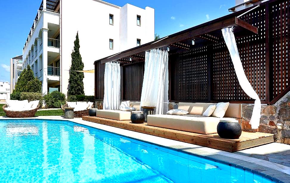 luxurious poolside cabana with white curtains