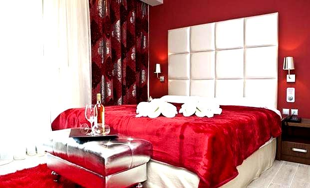 luxurious room with bold red decor and white headboard