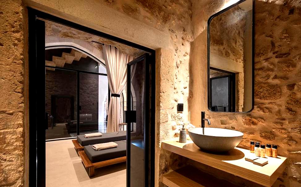 luxurious spa area with stone walls and relaxation beds