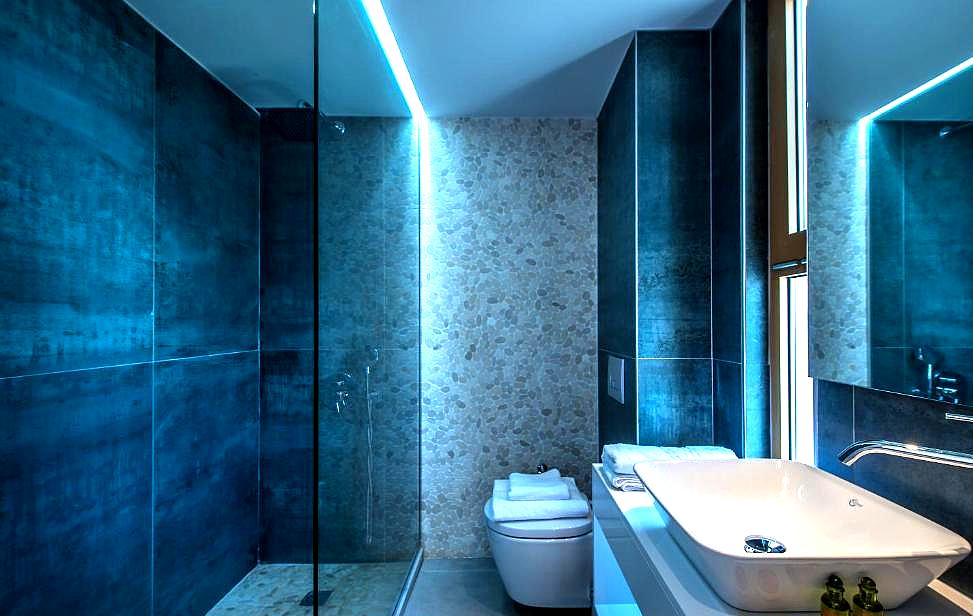 luxury bathroom with rain shower and modern lighting