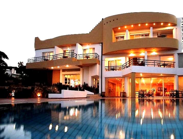 luxury hotel exterior with pool at night