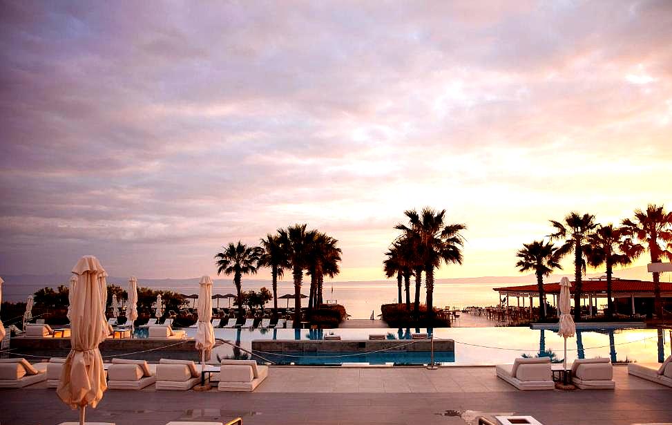 luxury poolside lounge with cabanas and sea view