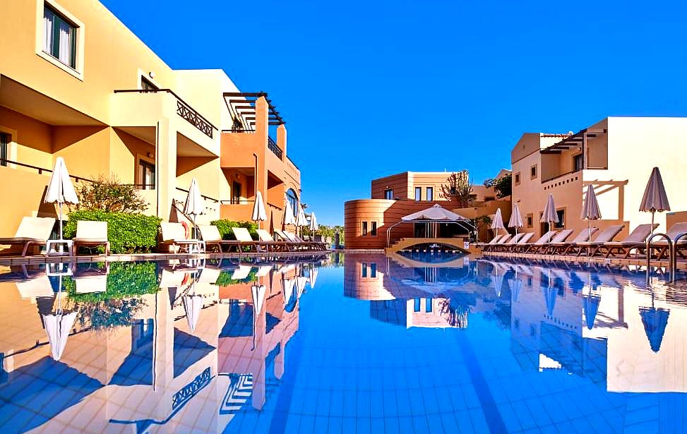 luxury swimming pool with poolside loungers and umbrellas