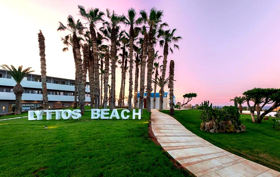 lyttos beach hotel sign with palm trees