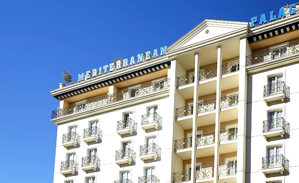 mediterranean style hotel exterior with balconies and pillars