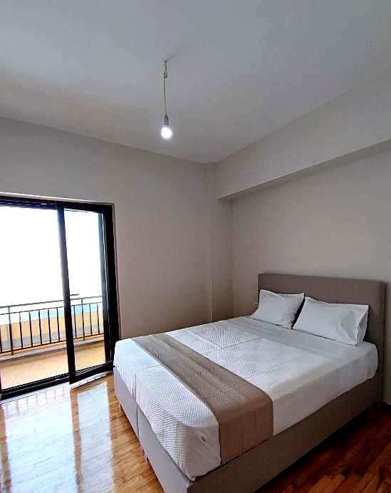 minimal bedroom with sea view and balcony access