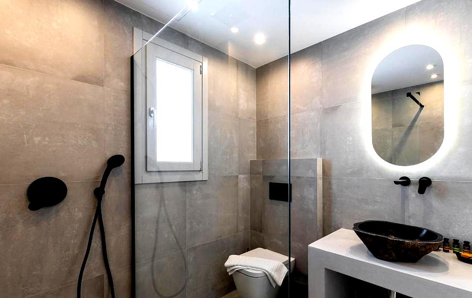 minimalist bathroom with modern fixtures and glass shower