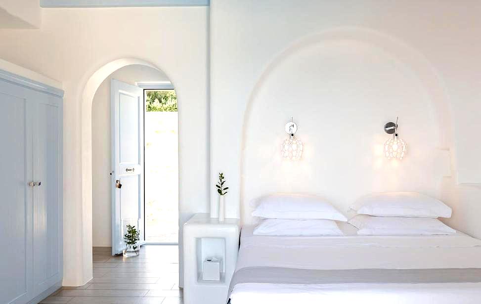 minimalist white bedroom with arch details