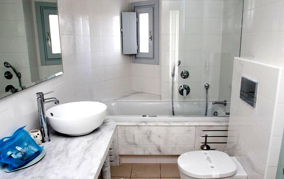 modern bathroom with marble counter and soaking tub