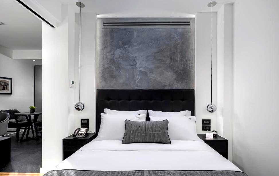 modern bedroom with black and white decor and stylish lighting