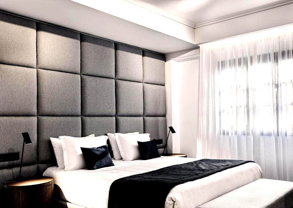 modern bedroom with padded wall and minimalist design