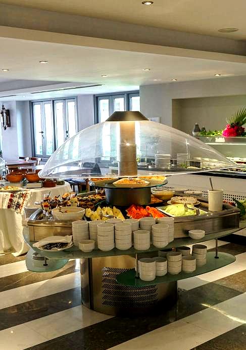 modern buffet restaurant with variety of dishes under glass canopy