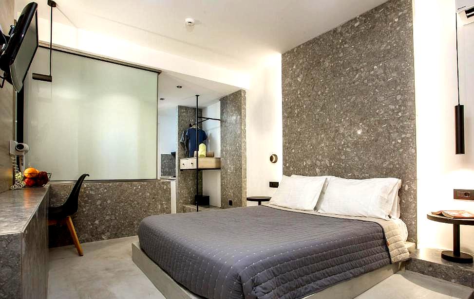 modern hotel room with marble walls and comfortable bed